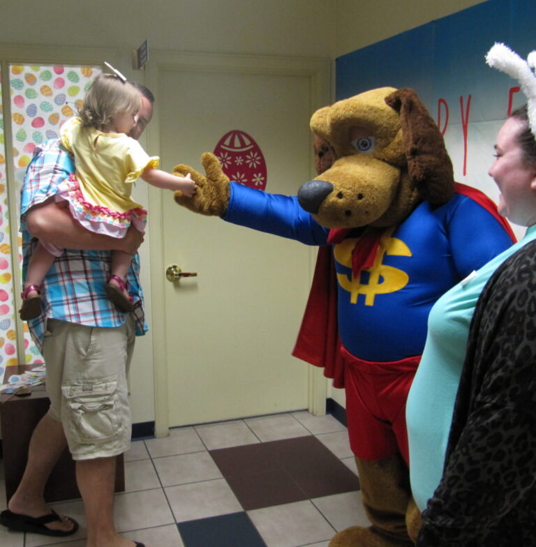 Dollar Dog shaking the hand of young girl